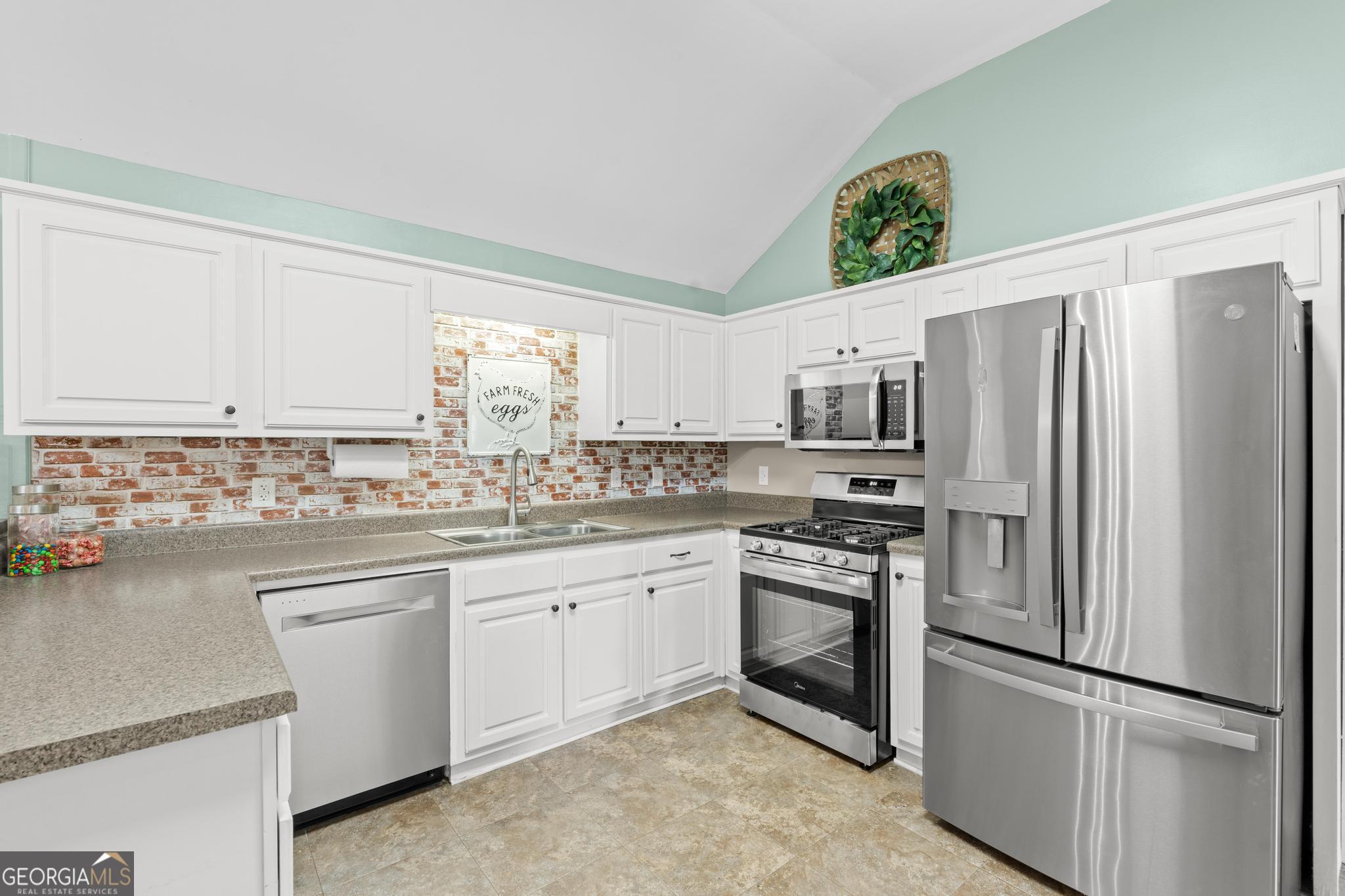 291 Lora Smith Road Newnan, GA 30265 - Photo 15 of 37 a kitchen with stainless steel appliances granite countertop a refrigerator sink and stove