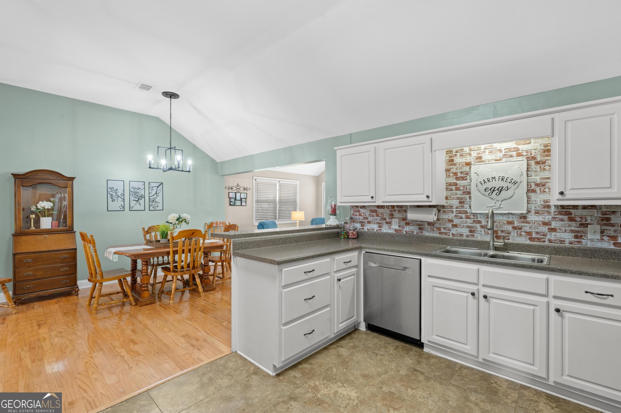 291 Lora Smith Road Newnan, GA 30265 - Photo 16 of 37 a kitchen with sink and cabinets