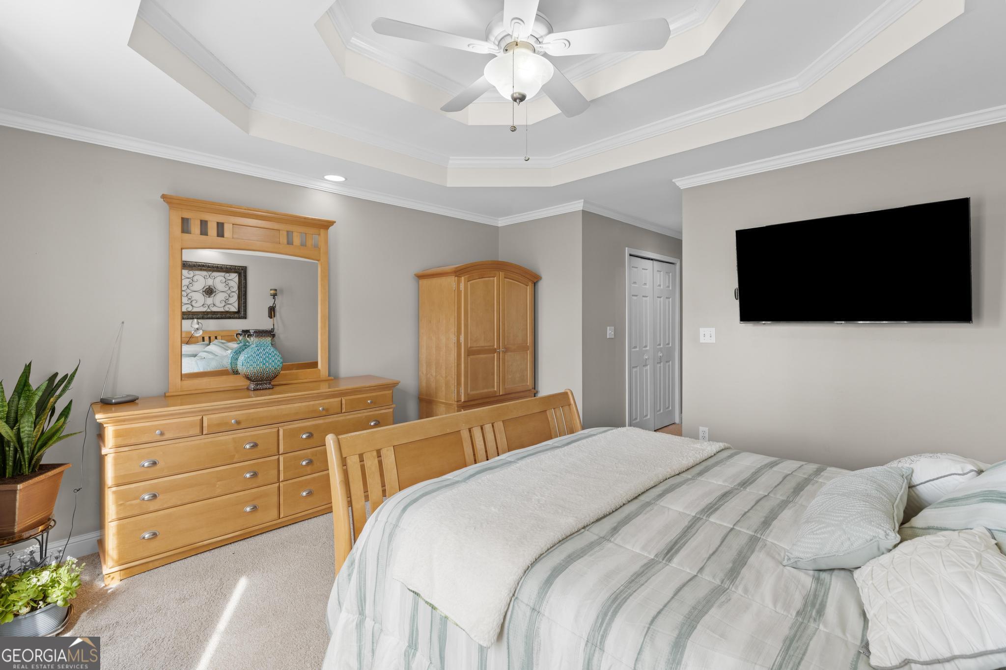 291 Lora Smith Road Newnan, GA 30265 - Photo 21 of 37 a bedroom with a large bed and a flat screen tv