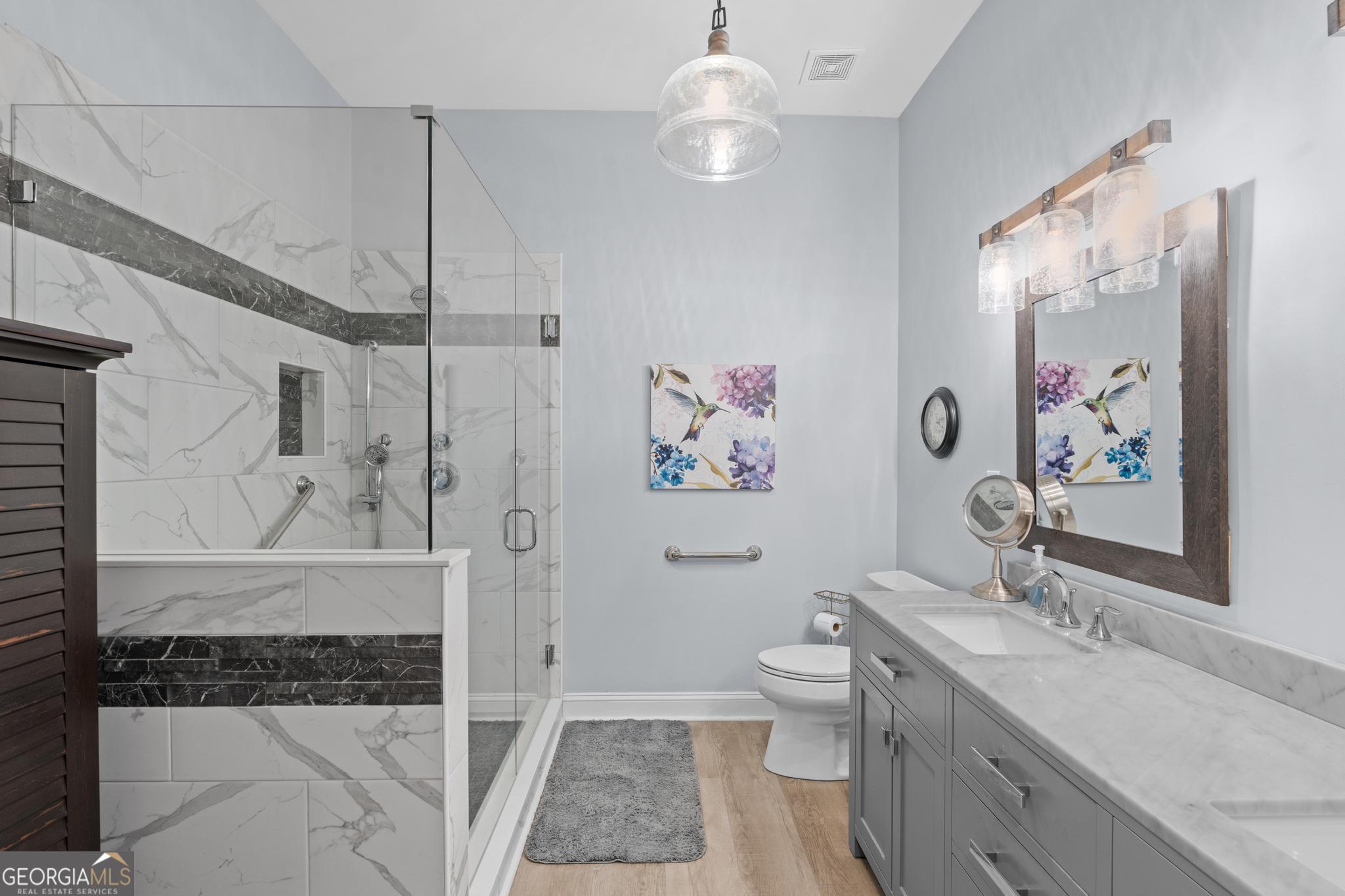 291 Lora Smith Road Newnan, GA 30265 - Photo 24 of 37 a spacious bathroom with a sink a toilet and a shower