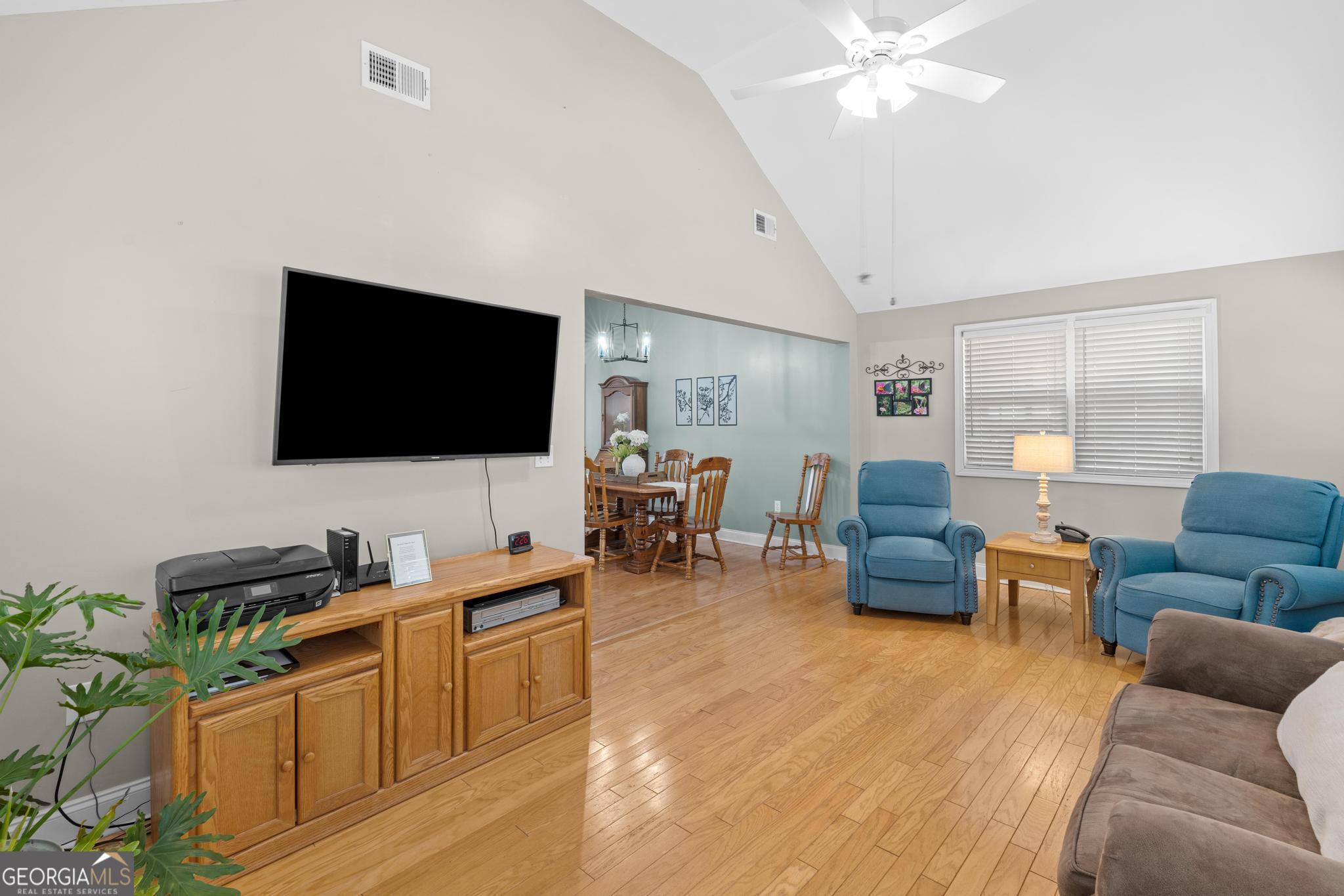 291 Lora Smith Road Newnan, GA 30265 - Photo 26 of 37 a living room with furniture and a flat screen tv