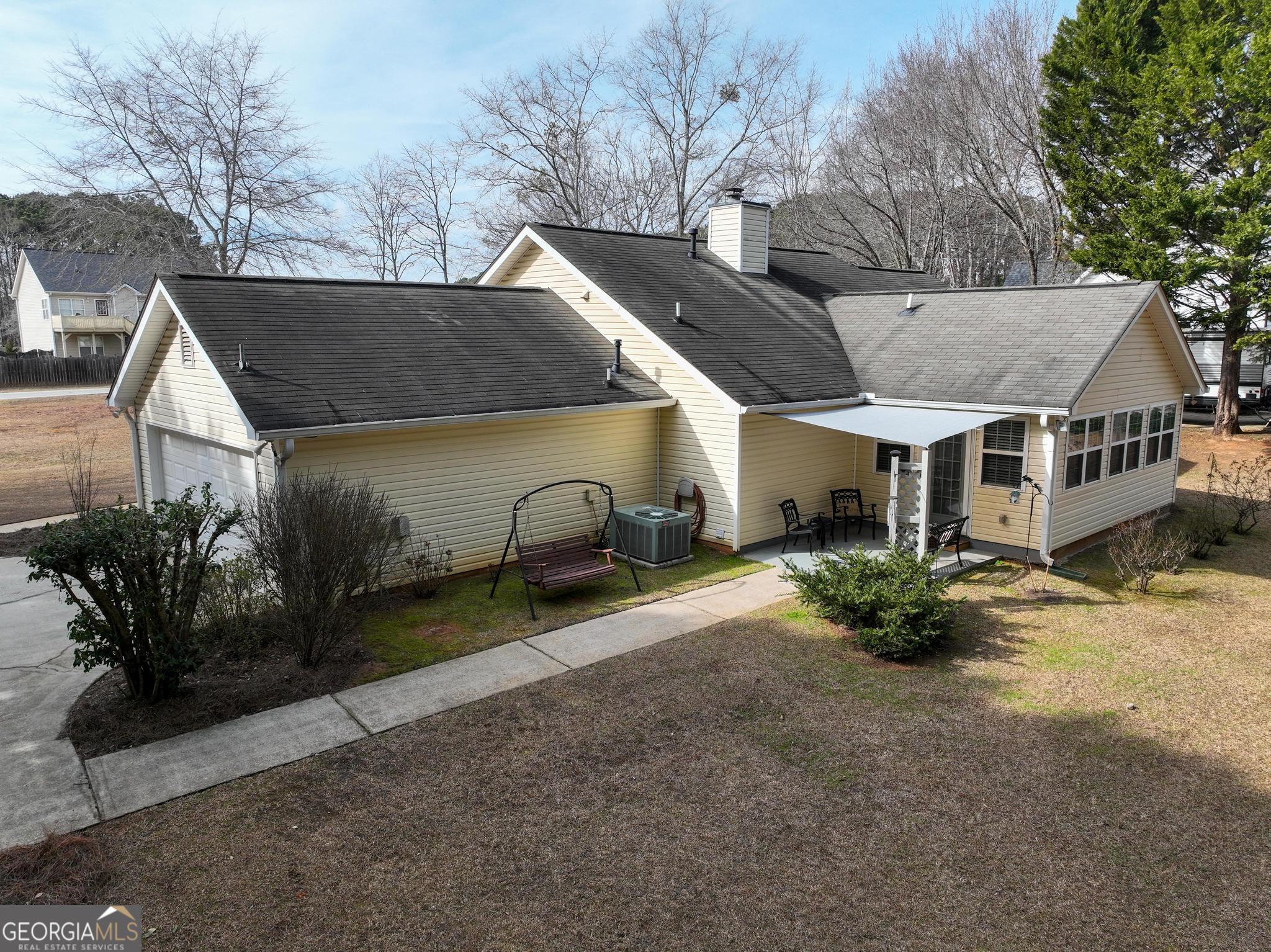 291 Lora Smith Road Newnan, GA 30265 - Photo 27 of 37 a view of a house with a patio and a yard