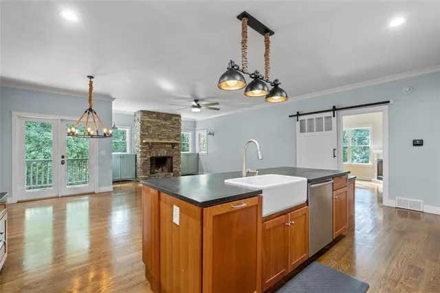 a view of an empty room with a fireplace and a window