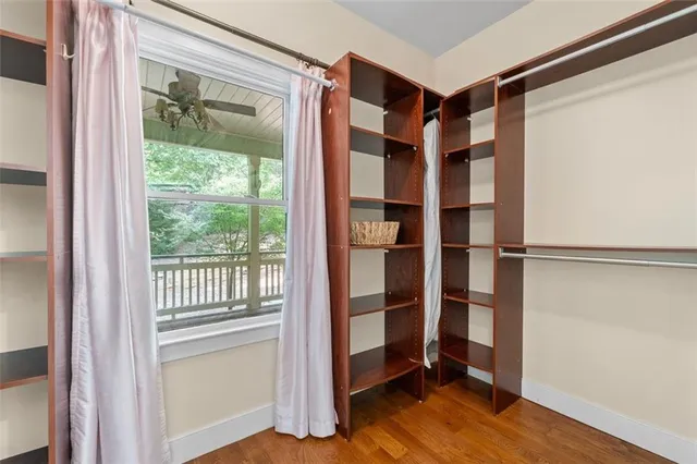 a bathroom with a toilet a sink a mirror and a window