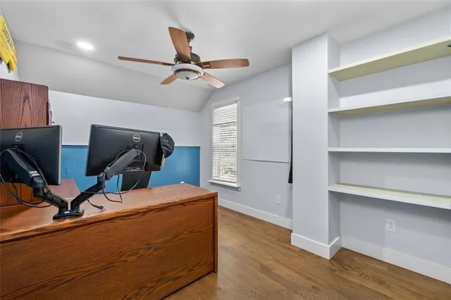 a living room with couch and a wooden floor