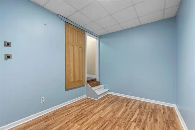 a kitchen with stainless steel appliances granite countertop a refrigerator a stove a sink dishwasher and a refrigerator with wooden floor