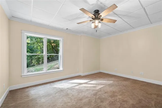 a bathroom with a granite countertop sink a mirror and shower