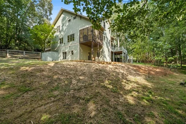 an aerial view of a house with garden space and a street view