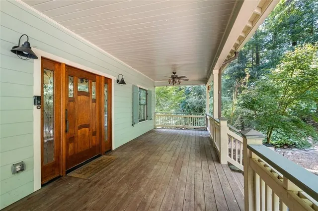 a view of a porch with wooden floor in front of house