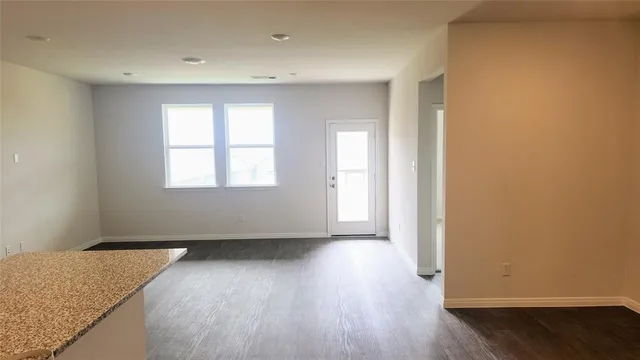 a kitchen with stainless steel appliances granite countertop a refrigerator a stove a sink a microwave and cabinets