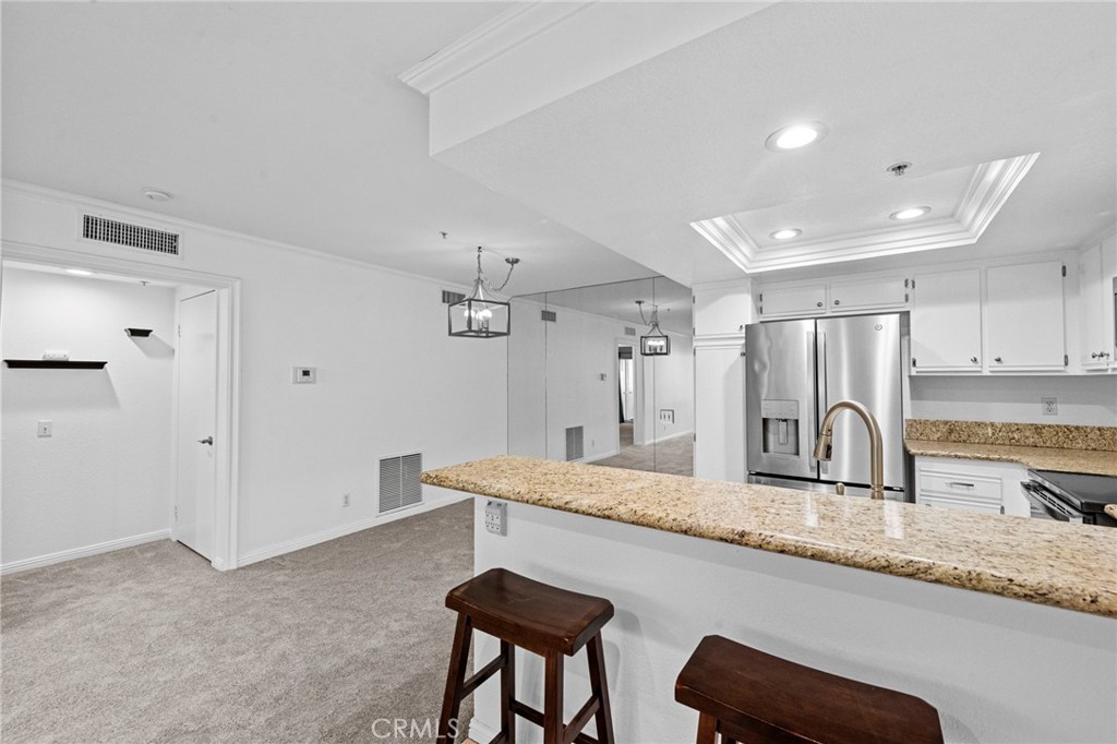 215 South Cross Creek Road, Unit L Orange, CA 92869 - Photo 12 of 50 a kitchen with granite countertop a sink and a refrigerator