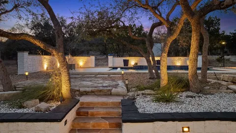 a backyard of a house with table and chairs