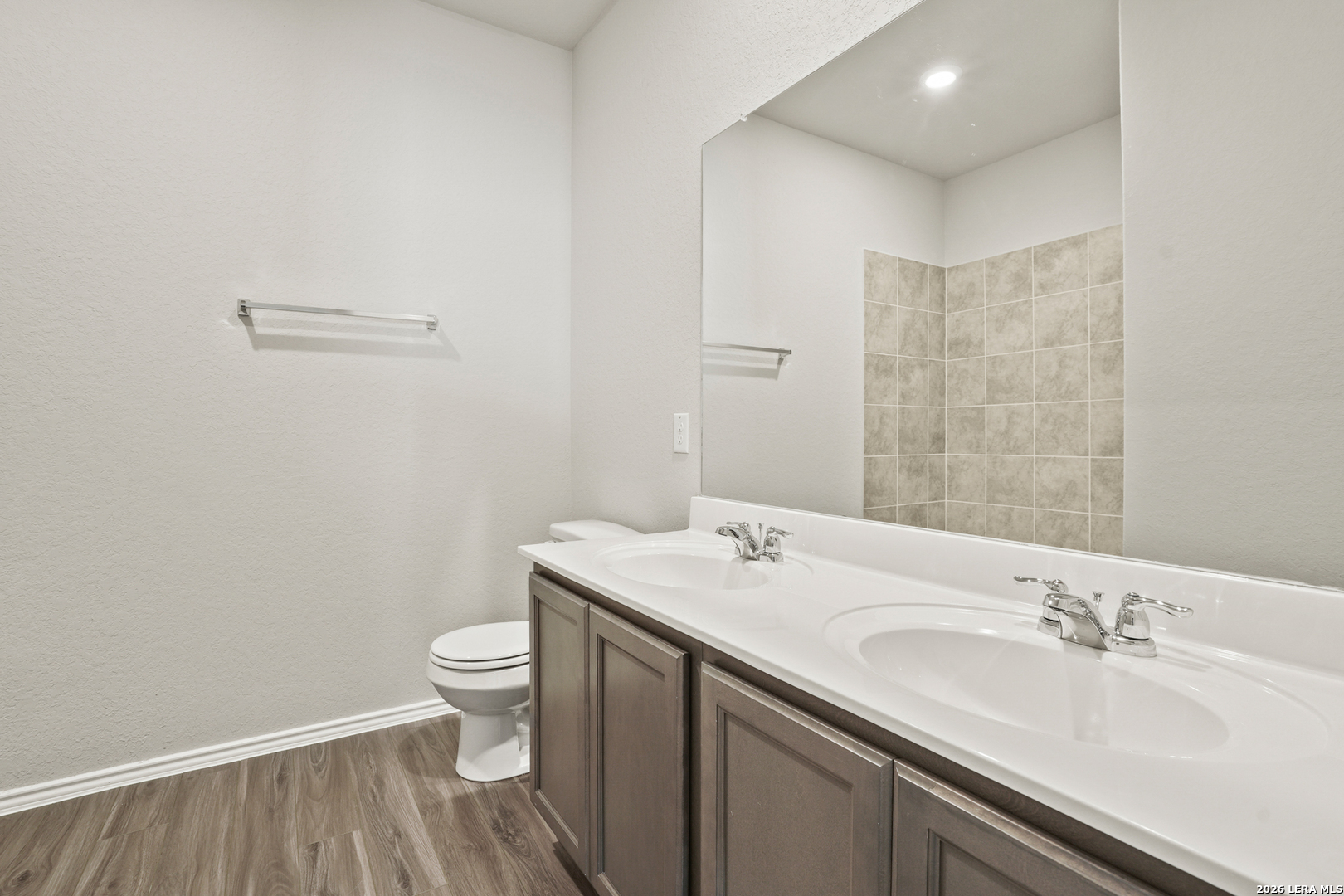 4951 Blue Ranch San Antonio, TX 78222 - Photo 14 of 36 a bathroom with a sink a toilet and a mirror
