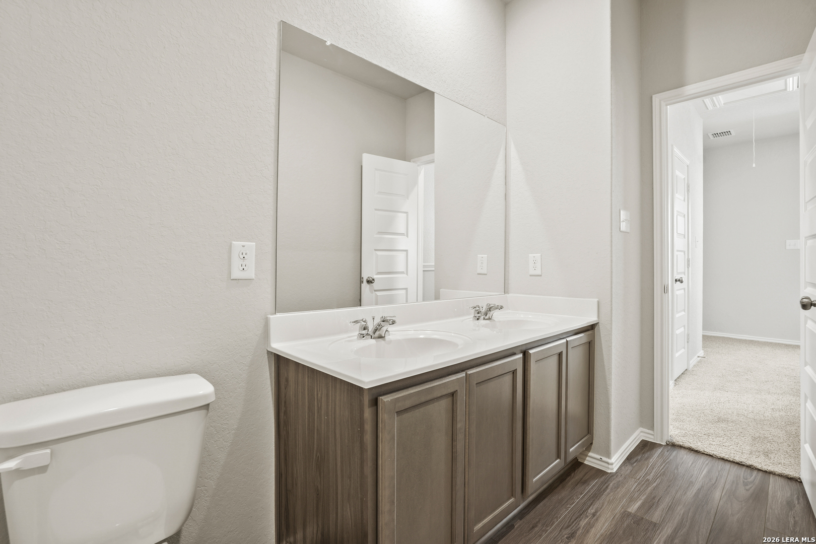 4951 Blue Ranch San Antonio, TX 78222 - Photo 15 of 36 a bathroom with a sink a toilet a mirror and vanity
