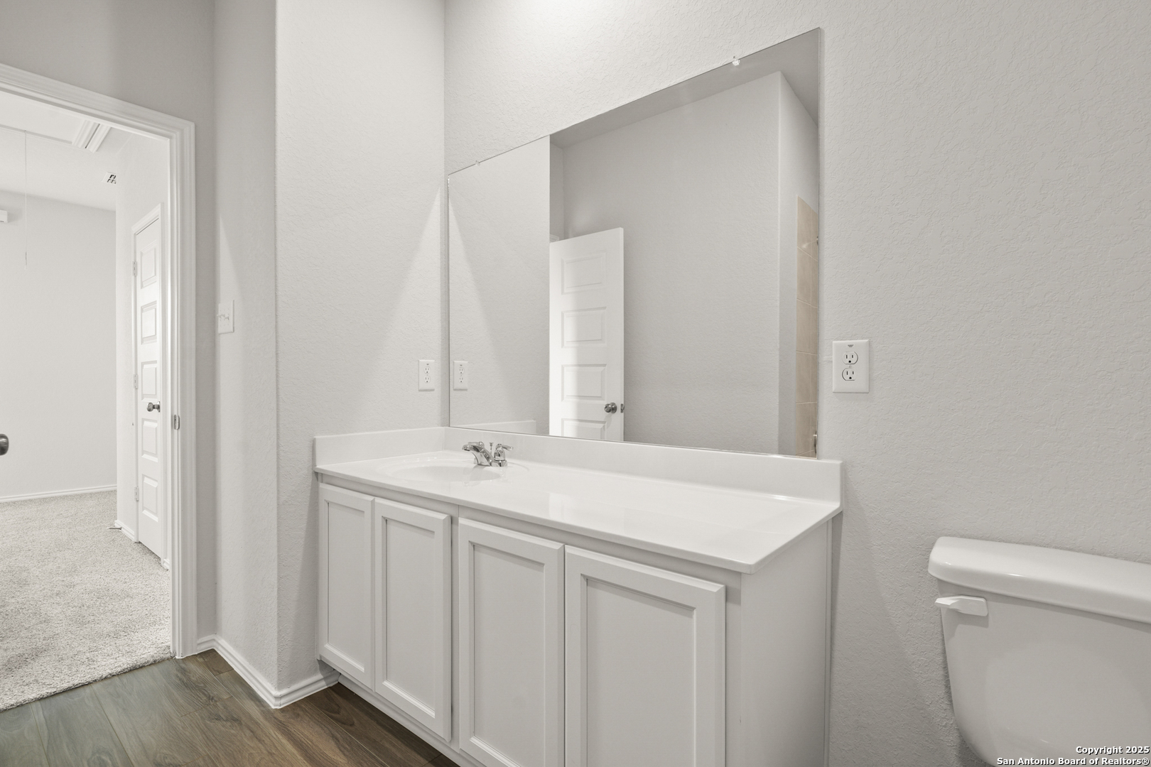 4951 Blue Ranch San Antonio, TX 78222 - Photo 16 of 24 a bathroom with a sink and a toilet