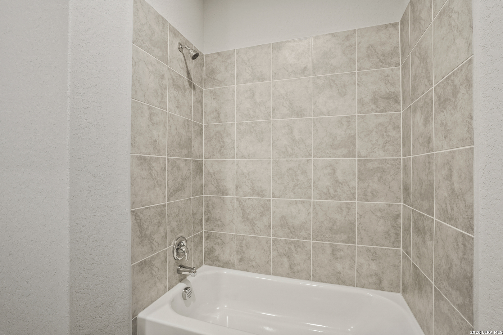 4951 Blue Ranch San Antonio, TX 78222 - Photo 16 of 36 a bath tub sitting next to a white sink and a shower