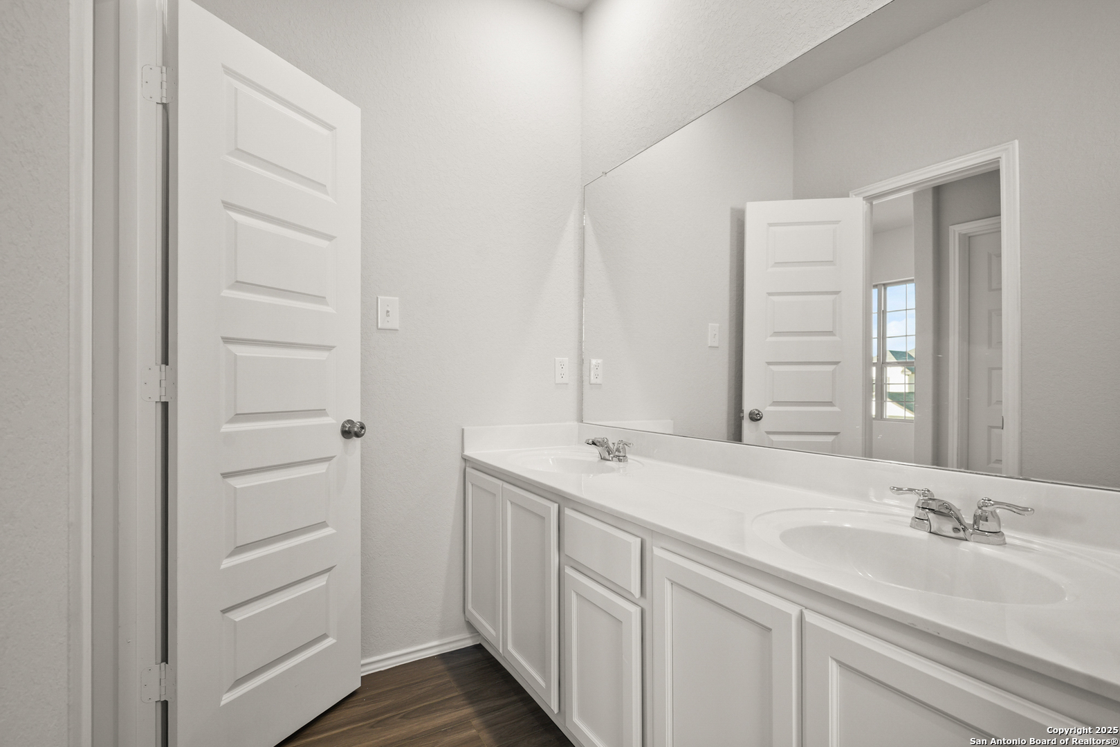 4951 Blue Ranch San Antonio, TX 78222 - Photo 23 of 24 a bathroom with a double vanity sink and a mirror
