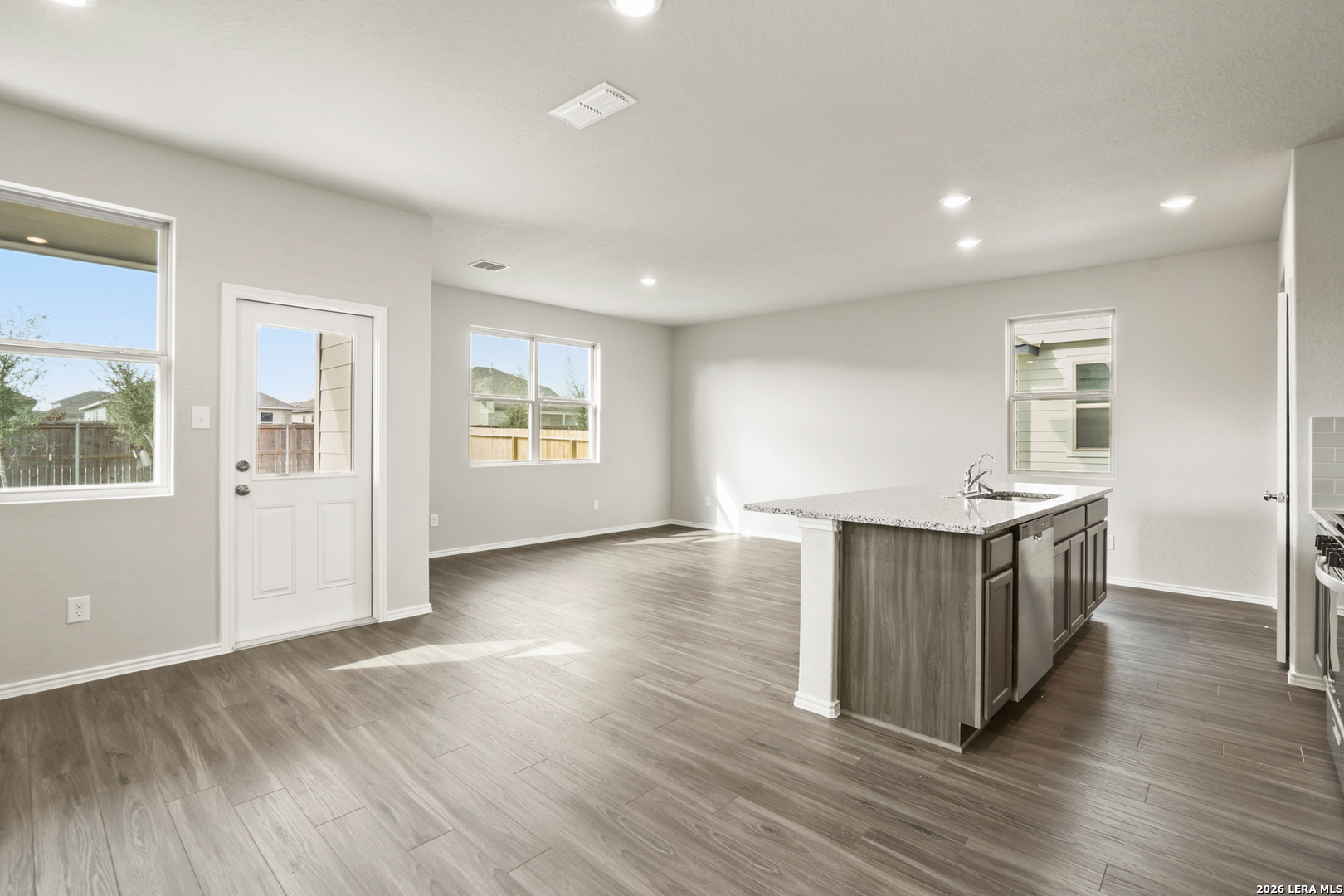 4951 Blue Ranch San Antonio, TX 78222 - Photo 4 of 36 an empty room with wooden floor and windows