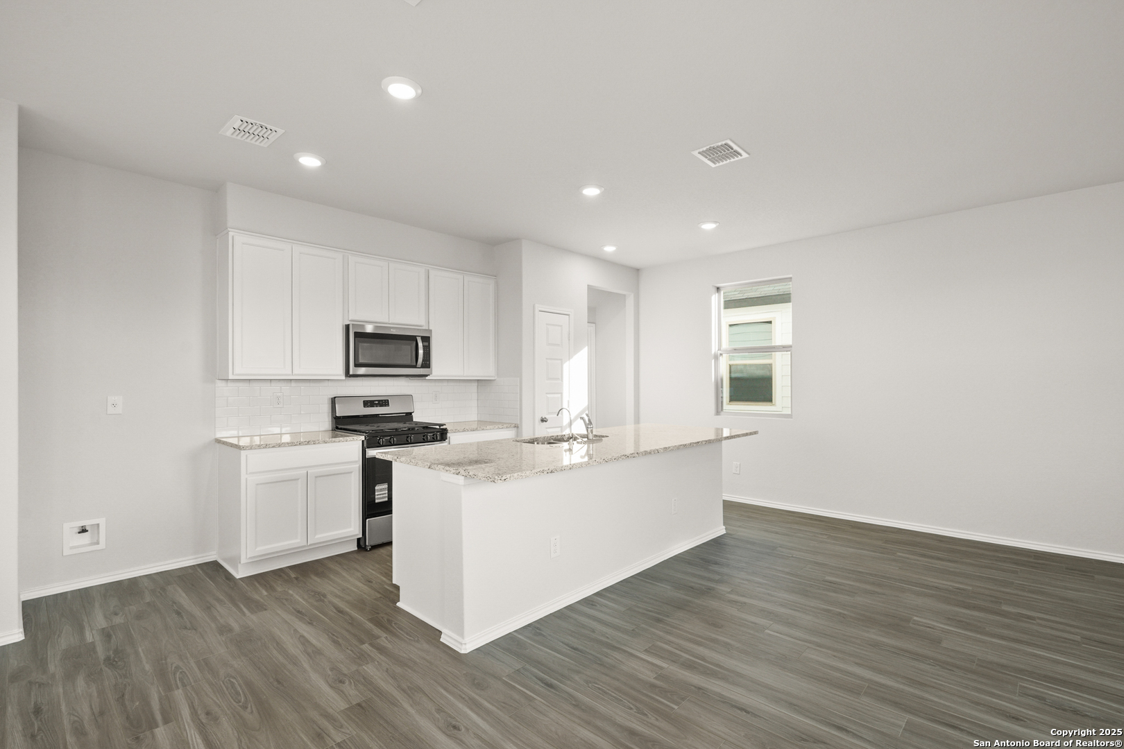 4951 Blue Ranch San Antonio, TX 78222 - Photo 4 of 24 a kitchen with cabinets and wooden floor