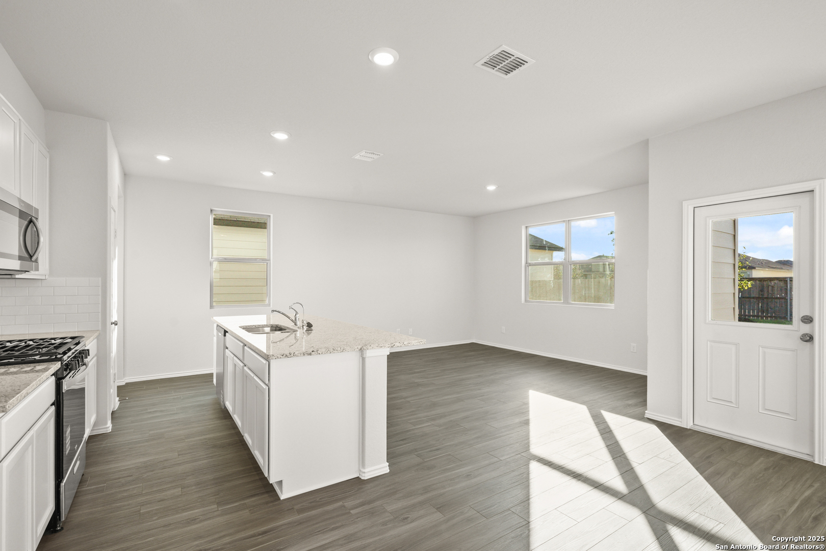 4951 Blue Ranch San Antonio, TX 78222 - Photo 5 of 24 a kitchen with stainless steel appliances granite countertop a stove and a wooden floors