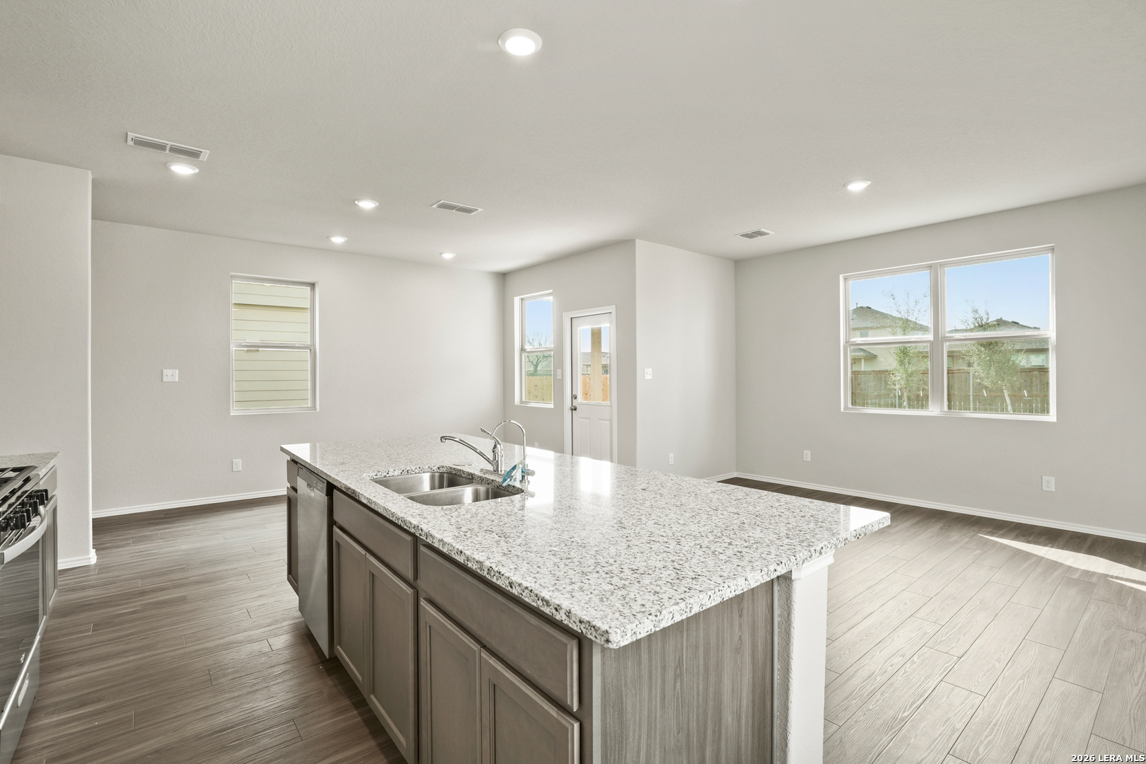 4951 Blue Ranch San Antonio, TX 78222 - Photo 7 of 36 a kitchen with granite countertop cabinets and wooden floor