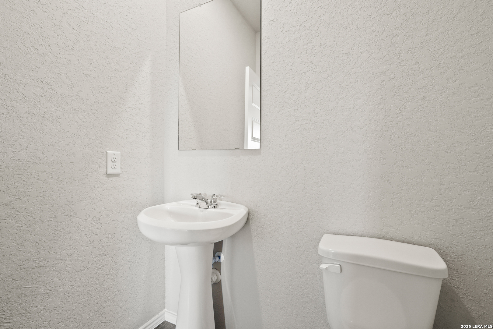 4951 Blue Ranch San Antonio, TX 78222 - Photo 10 of 36 a bathroom with a sink a toilet and mirror