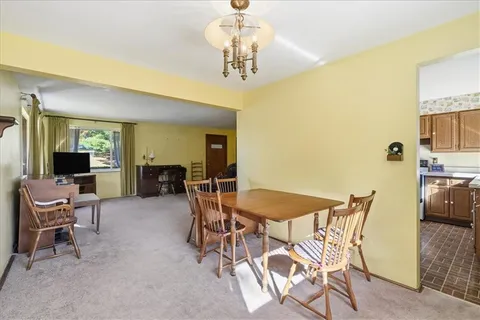 a view of a dining room with furniture and a chandelier