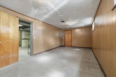 an empty room with fan and entrance