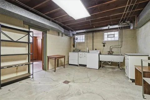a utility room with a sink and cabinets