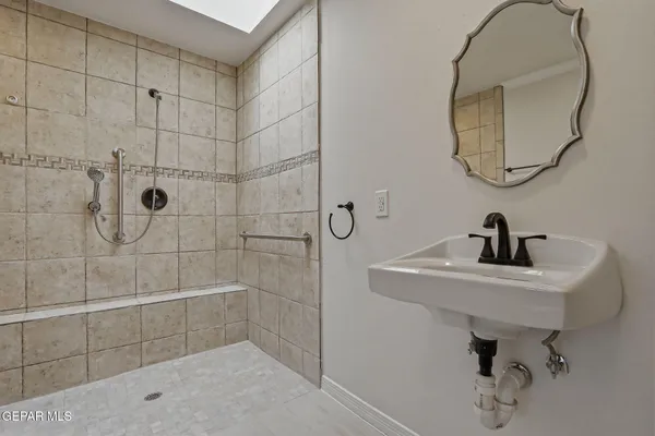 a bathroom with a sink a toilet and a mirror