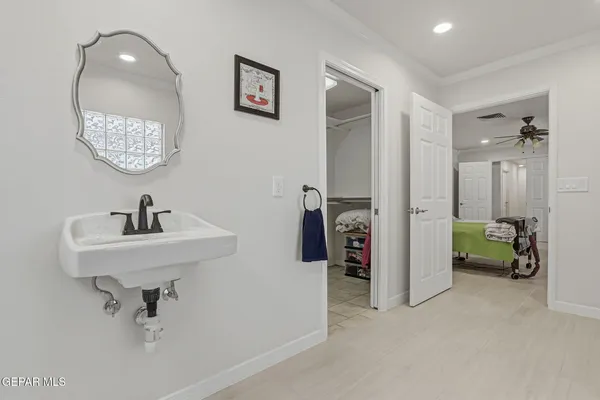 a bathroom with a sink a mirror and a shower