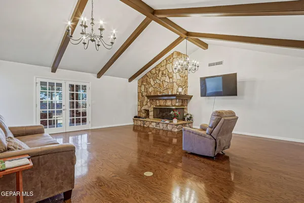 a living room with furniture and a chandelier