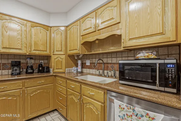 a kitchen with stainless steel appliances granite countertop a stove and cabinets