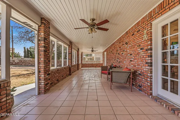 a view of a porch with wooden floor and furniture