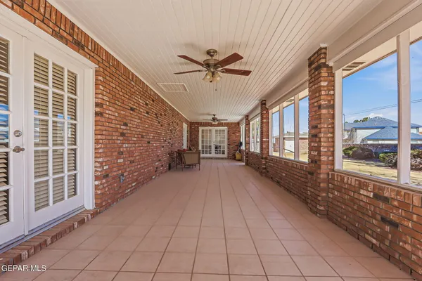 a view of a porch with a table and chairs