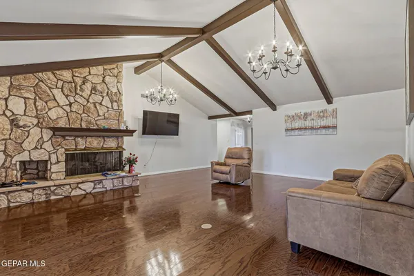 a living room with furniture wooden floor and a flat screen tv