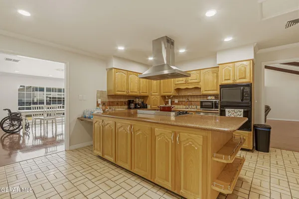 a kitchen with stainless steel appliances granite countertop a sink and a refrigerator