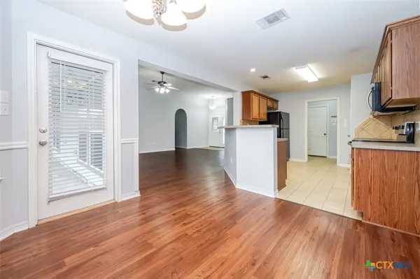 an empty room with a empty space and a ceiling fan