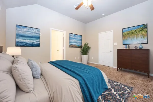 a bedroom with a bed and a painting on the wall