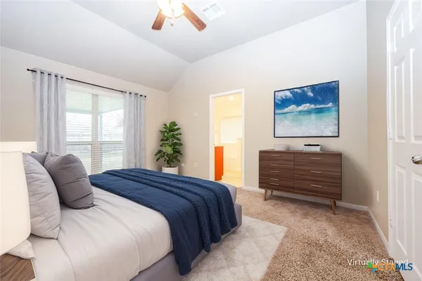 a bedroom with a bed and a window
