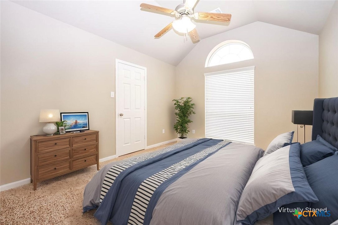 7531 Amber Meadow Loop Temple, TX 76502 - Photo 9 of 31 a bedroom with a bed and a chandelier