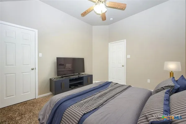 a bedroom with a bed and a television
