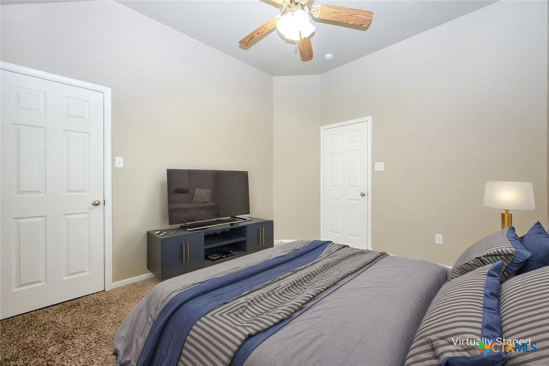 7531 Amber Meadow Loop Temple, TX 76502 - Photo 10 of 31 a bedroom with a bed and a television