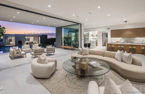 a living room with kitchen couches and kitchen view