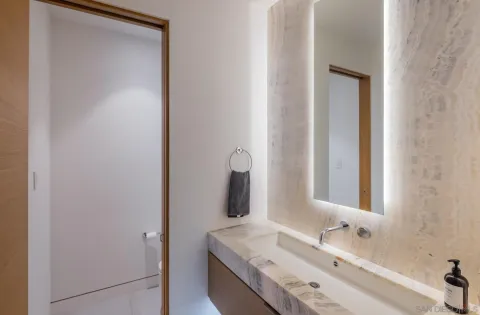 a bathroom with a tub sink and mirror