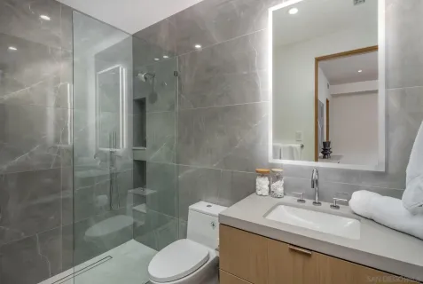 a bathroom with a sink toilet and shower