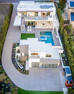 an aerial view of a house with swimming pool and patio