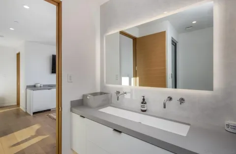 a bathroom with a tub sink and mirror