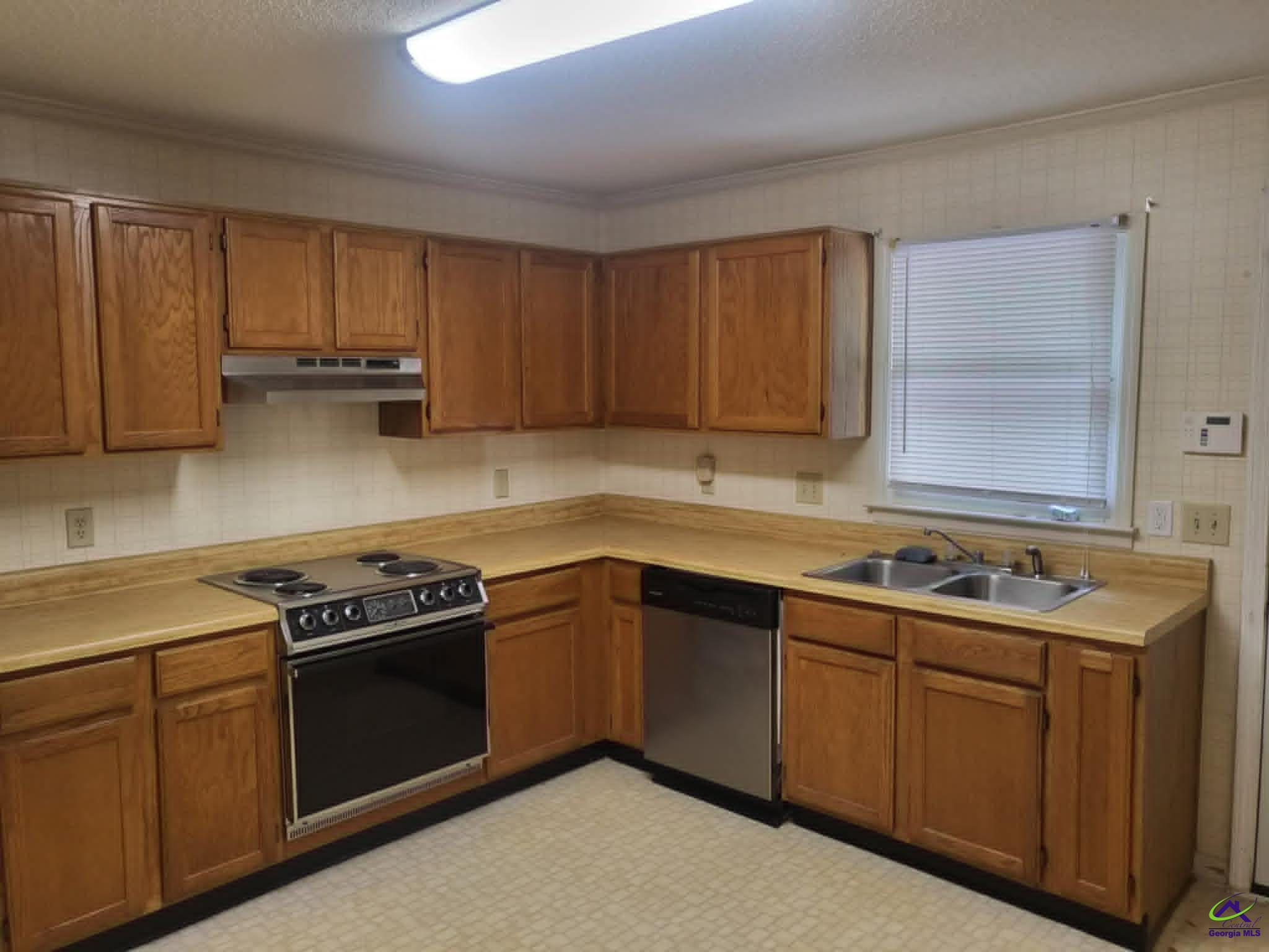 4472 Club Trace Macon, GA 31210 - Photo 6 of 10 a kitchen with a sink stove top oven and cabinets