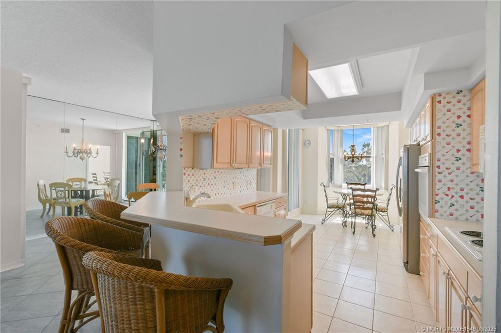 8650 South Ocean Drive, Unit 306 Jensen Beach, FL 34957 - Photo 11 of 51 a dining room with furniture and a large window
